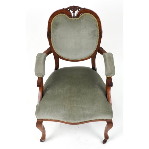 2135 - Victorian style armchair with olive green upholstery on cabriole legs with casters, 95cm high