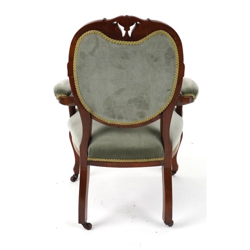 2135 - Victorian style armchair with olive green upholstery on cabriole legs with casters, 95cm high