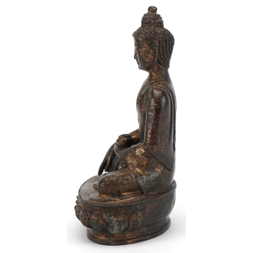 95 - Chino Tibetan partially gilt bronze figure of seated Buddha, 20.5cm high