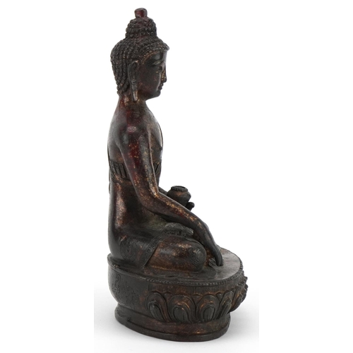 95 - Chino Tibetan partially gilt bronze figure of seated Buddha, 20.5cm high