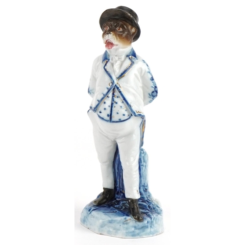 Continental blue and white 19th century comical porcelain spill vase in the form of a monkey in a suit, blue anchor marks to the base, 16cm high