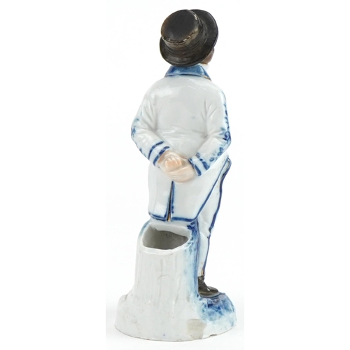 126 - Continental blue and white 19th century comical porcelain spill vase in the form of a monkey in a su... 