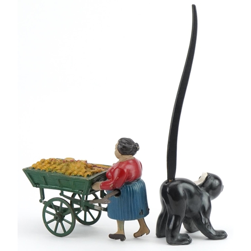 317 - Vintage clockwork street trader and a novelty porcelain monkey with wagging tail, the largest 24cm w... 