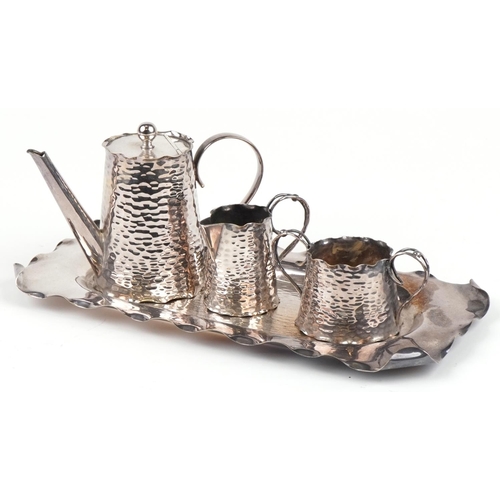 398 - Arts & Crafts silver plated three piece tea set on tray, the largest 32 cm wide