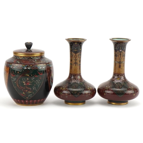 71 - Japanese cloisonne comprising a pair of vases and a jar and cover enamelled with phoenixes and mythi... 