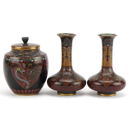 71 - Japanese cloisonne comprising a pair of vases and a jar and cover enamelled with phoenixes and mythi... 