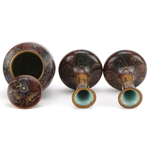 71 - Japanese cloisonne comprising a pair of vases and a jar and cover enamelled with phoenixes and mythi... 