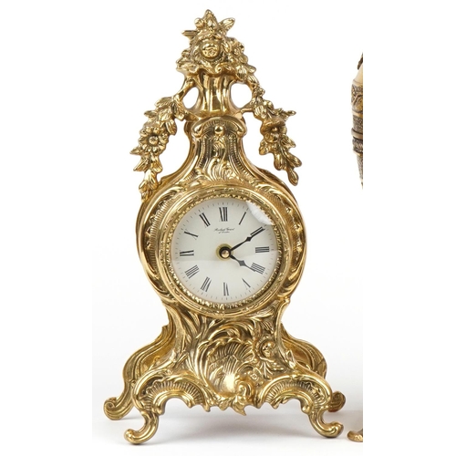 1087 - Two French Rococo style mantle clocks and a large brass ewer with C scroll decoration, the largest 5... 