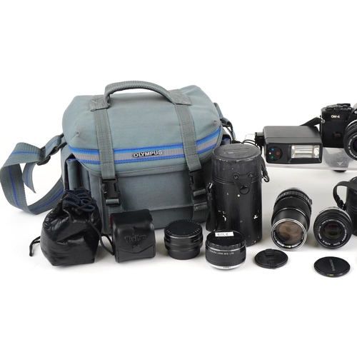 1338 - Canon OM-4 camera with various lenses and accessories, some with boxes