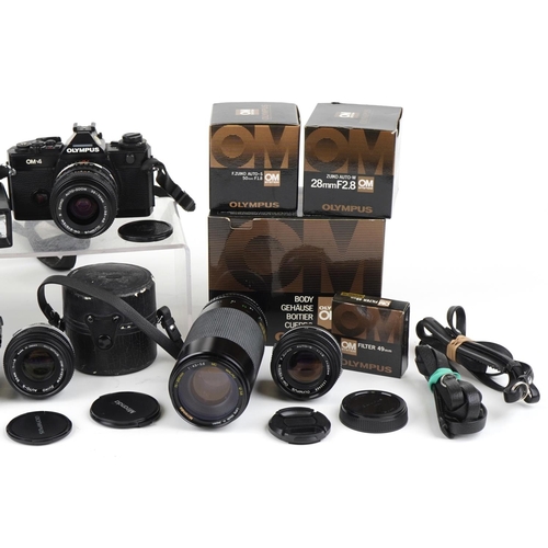 1338 - Canon OM-4 camera with various lenses and accessories, some with boxes