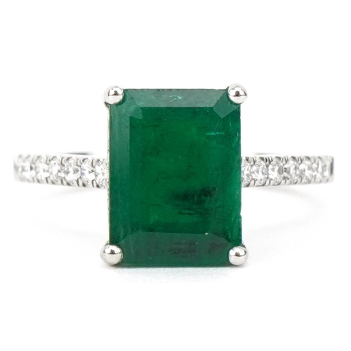 2205 - Platinum octagonal step cut emerald ring with diamond set shoulders, the emerald approximately 3.0 c... 