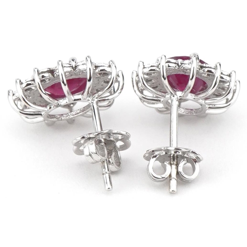 2098 - Pair of 18ct white gold ruby and round brilliant cut diamond cluster stud earrings, total diamond we... 