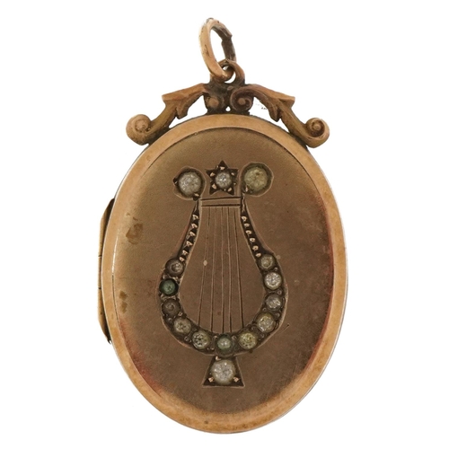 2100 - 9ct gold back and front locket with engraved lyre set with clear stones, 3cm high, 6.0g