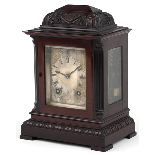 229 - 19th century carved mahogany mantle clock striking on a gong with silvered dial engraved with foliag... 