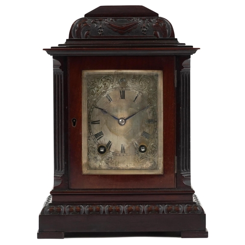 229 - 19th century carved mahogany mantle clock striking on a gong with silvered dial engraved with foliag... 