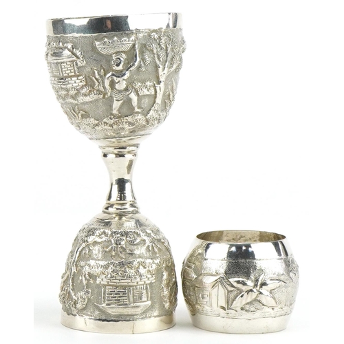 148 - Anglo Indian unmarked silver double ended eggcup profusely embossed with figures gathering food in a... 