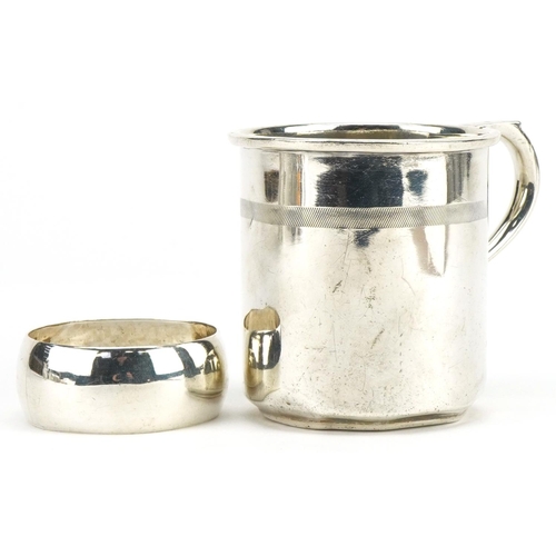 294 - Continental 935 grade silver christening tankard and a white metal napkin ring, the tankard 6.5cm hi... 