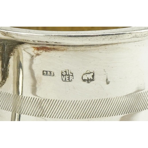 294 - Continental 935 grade silver christening tankard and a white metal napkin ring, the tankard 6.5cm hi... 