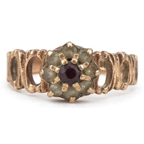 2174 - 9ct gold garnet and clear stone flower head ring with pierced bark design shoulders, size I, 2.3g