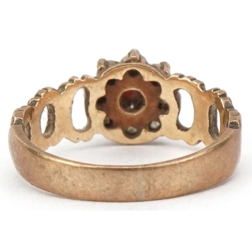 2174 - 9ct gold garnet and clear stone flower head ring with pierced bark design shoulders, size I, 2.3g