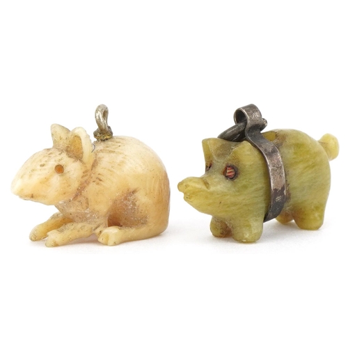 2744 - Two animal charms including a carved green stone pig with unmarked silver mount, the largest 2.1cm i... 