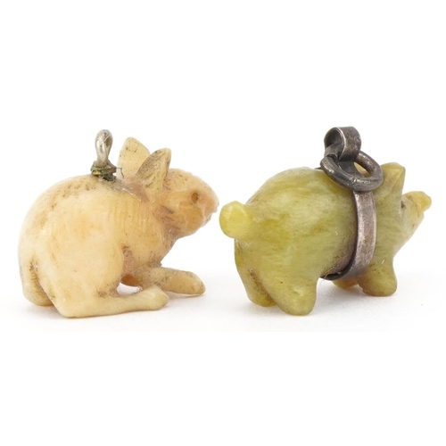 2744 - Two animal charms including a carved green stone pig with unmarked silver mount, the largest 2.1cm i... 