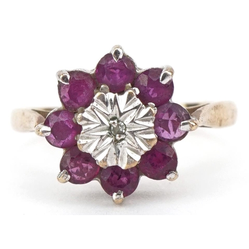 2126 - 9ct gold ruby and diamond flower head ring, size J/K, 2.2g