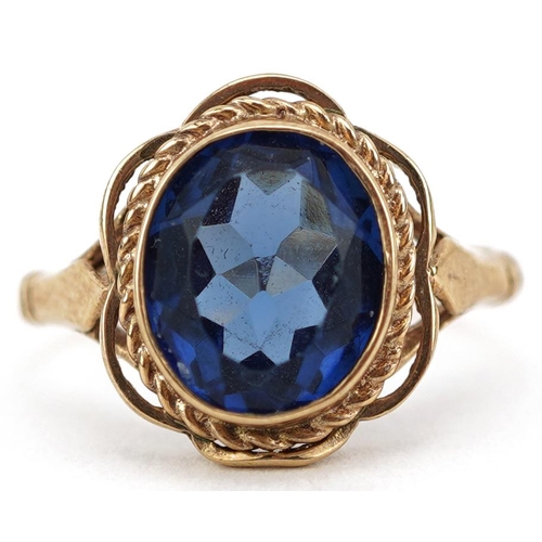 2107 - 9ct gold blue stone solitaire ring with pierced rope twist setting, size L, 3.0g