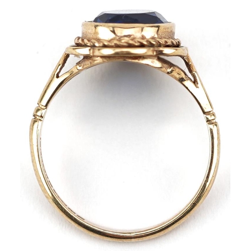 2107 - 9ct gold blue stone solitaire ring with pierced rope twist setting, size L, 3.0g