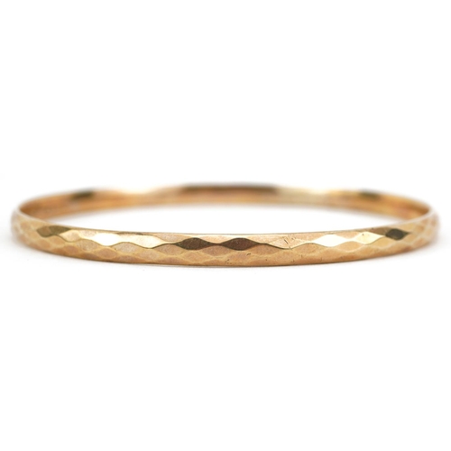 2750 - Large 9ct gold metal core bangle, 8.5cm in diameter, 27.0g