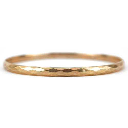 2750 - Large 9ct gold metal core bangle, 8.5cm in diameter, 27.0g