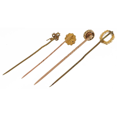 2165 - Four antique gold and yellow metal stickpins including one with cultured pearl and diamonds, the lar... 