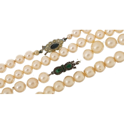 2763 - Two vintage simulated pearl necklaces, the clasps set with colourful stones, the largest 58cm in len... 