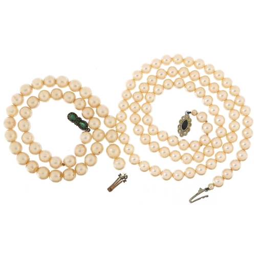 2763 - Two vintage simulated pearl necklaces, the clasps set with colourful stones, the largest 58cm in len... 