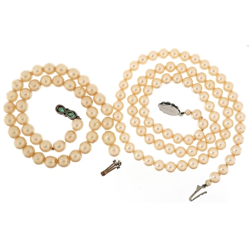 2763 - Two vintage simulated pearl necklaces, the clasps set with colourful stones, the largest 58cm in len... 