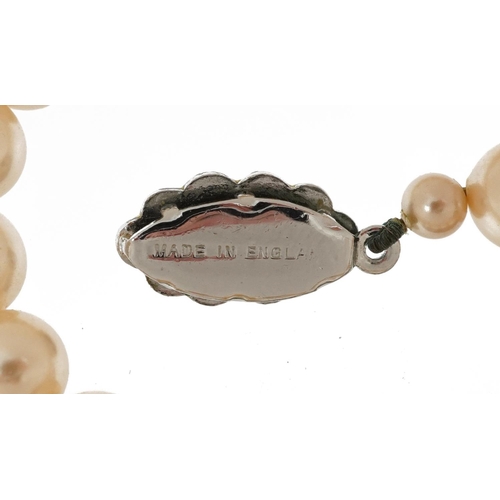 2763 - Two vintage simulated pearl necklaces, the clasps set with colourful stones, the largest 58cm in len... 