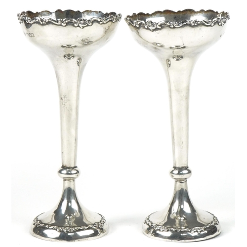 188 - Horace Woodward & Co Ltd, pair of Arts & Crafts weighted silver tapering candlesticks with foliate r... 