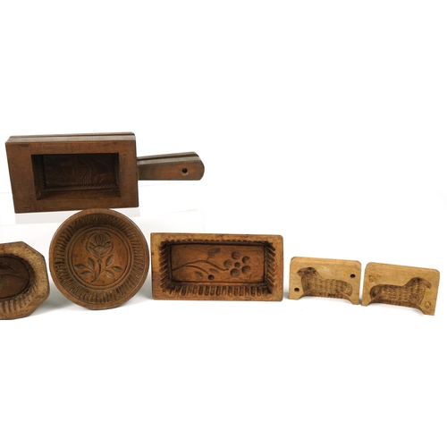 247 - Six Antique French treen butter moulds including examples carved with flowers, the largest 20.5cm in... 