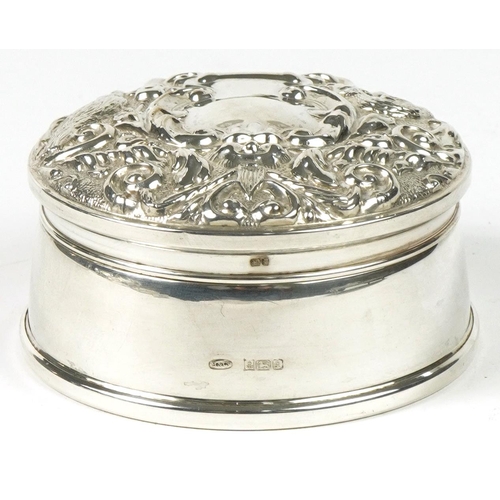 218 - W I Broadway & Co, Elizabeth II circular silver jewel box, the hinged lid profusely embossed with bi... 