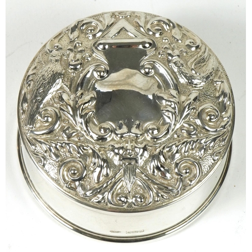 218 - W I Broadway & Co, Elizabeth II circular silver jewel box, the hinged lid profusely embossed with bi... 