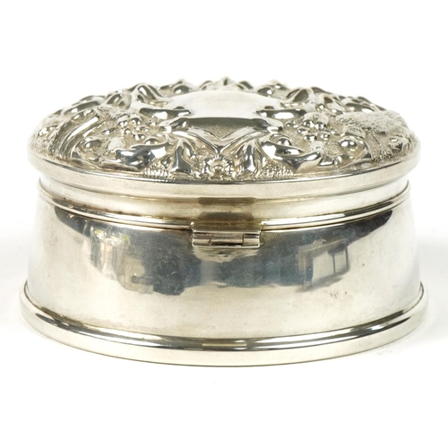 218 - W I Broadway & Co, Elizabeth II circular silver jewel box, the hinged lid profusely embossed with bi... 