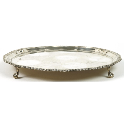 62 - Joseph Rodgers & Sons Ltd, circular silver salver raised on four ball and claw feet, Sheffield 1936,... 