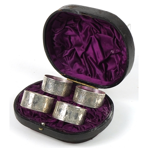 267 - Levesley Brothers, set of four Victorian engraved circular silver napkin rings housed in a velvet an... 