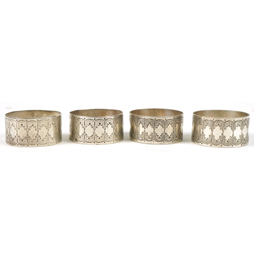 267 - Levesley Brothers, set of four Victorian engraved circular silver napkin rings housed in a velvet an... 