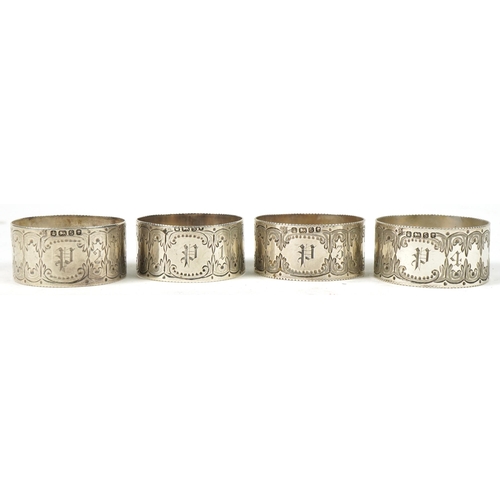 267 - Levesley Brothers, set of four Victorian engraved circular silver napkin rings housed in a velvet an... 