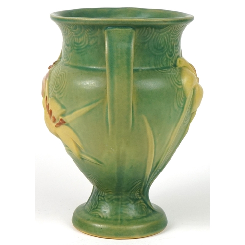 286 - Roseville, American pottery twin handled vase decorated in relief with flowers, 21.5cm high