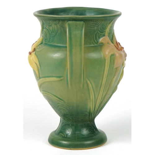 286 - Roseville, American pottery twin handled vase decorated in relief with flowers, 21.5cm high