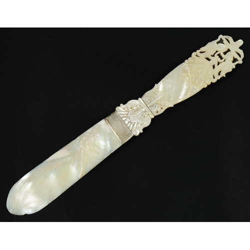 187 - 19th century mother of pearl page turner with floral carved handle and white metal mount, 26.5cm in ... 