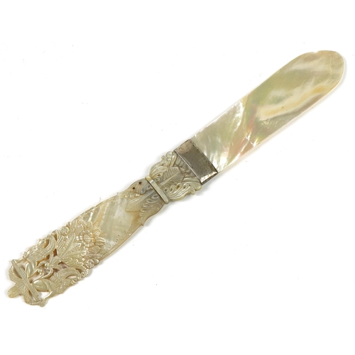 187 - 19th century mother of pearl page turner with floral carved handle and white metal mount, 26.5cm in ... 