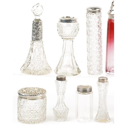 131 - Victorian and later silver mounted glassware including cranberry glass casters, scent bottles and si... 